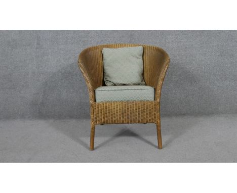 A vintage Lusty Lloyd Loom tub chair with makers label. 