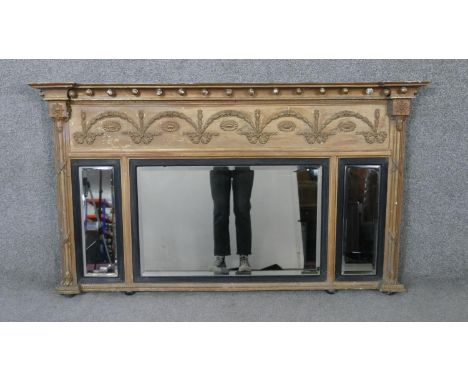 A Regency giltwood and gesso overmantel mirror with ball decorated architectural pediment above swag decorated frieze and tri