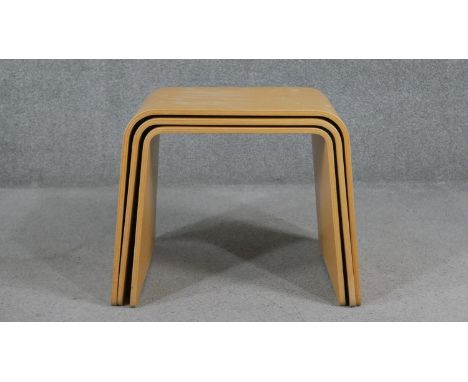 A nest of three contemporary vintage style tables in laminated plywood. H.46 W.58 D.33cm 