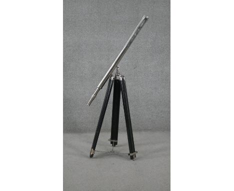 A reproduction chrome telescope on ebonised adjustable tripod base. (damaged) H.93 W.87cm 
