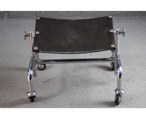 A vintage chrome framed adjustable footstool on casters, maker's mark to frame. H.33 W.45 D.35cm. 