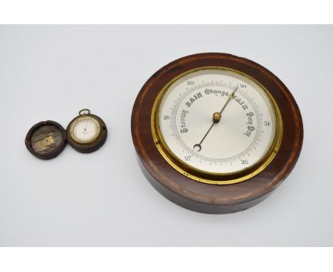 An Edwardian mahogany and satinwood inlaid barometer with silvered dial along with a cased pocket barometer. Dia.24 D.5cm 