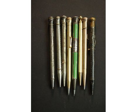 A collection of eight vintage and antique propelling pencils, including a day date silver and enamel calendar pencil, a gold 