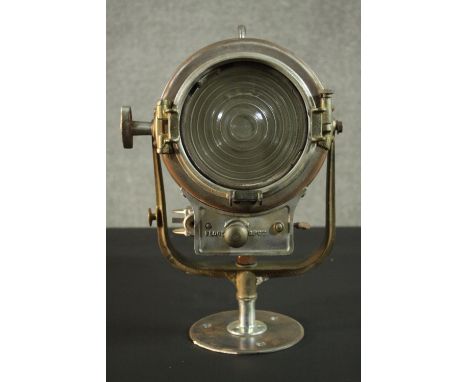 A vintage Mole-Richardson theatre spotlight and hinged wall bracket. Relief makers mark. H.20 Dia.22cm. 