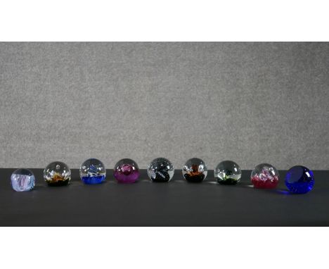 A collection of nine limited edition Caithness lamp work glass paperweights. Stamped to the base. H.8 W.8cm (largest) 