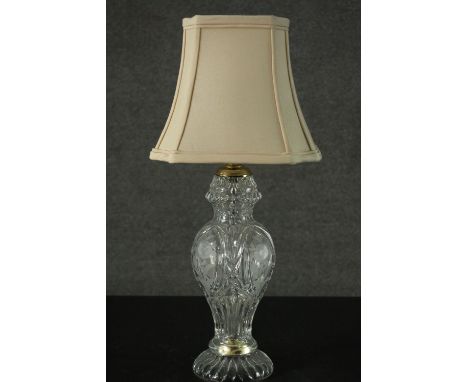 A vintage cut crystal vase design table lamp with etched floral design and cream silk shade. H.57cm 