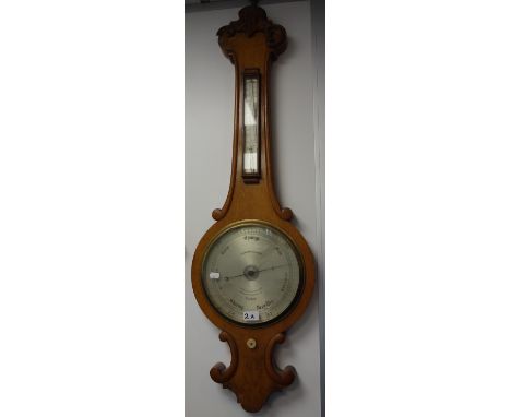 A VICTORIAN WHEEL BAROMETER by Negretti &amp; Zambra with silver dial (examine)&nbsp;