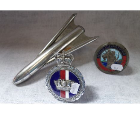 A VINTAGE 1950S CAR MASCOT in the form of a rocket, a chrome and enamel Naval car badge and a St Christopher car badge (3)