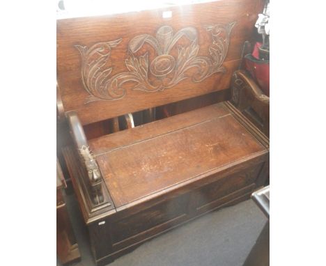 A CARVED OAK MONK'S BENCH