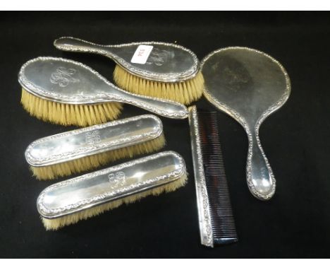 A SILVER DRESSING TABLE SET, comprising brushes, comb and hand mirror