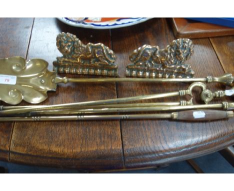 A PAIR OF 19TH CENTURY CAST BRASS CHIMNEY ORNAMENTS in the form of recumbent lions, a 19th Century toasting fork and a set of
