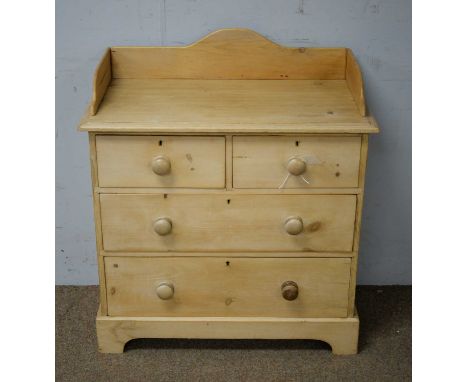 A 20th Century stripped pine chest of drawers, with 3/4 gallery and rectangular top, above an arrangement of two short over t