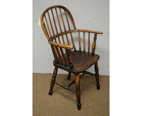 A late 19th Century ash and elm Windsor chair, the hopped top rail with stick back and outswept arms, above a solid seat, rai