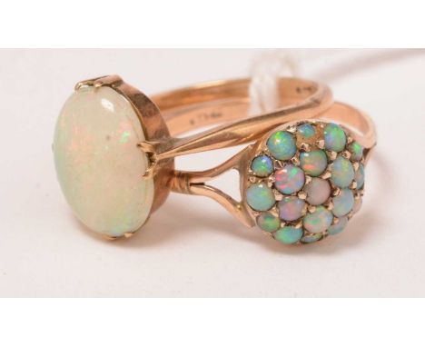 Two opal and yellow-metal rings, one in the form of a cluster, each marked 9ct, 3.3g gross.