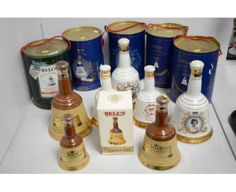 Four Bell's Scotch Whisky Royal Commemorative decanters, each in tube; along with a Bell's Scotch Whisky Christmas decanter, 