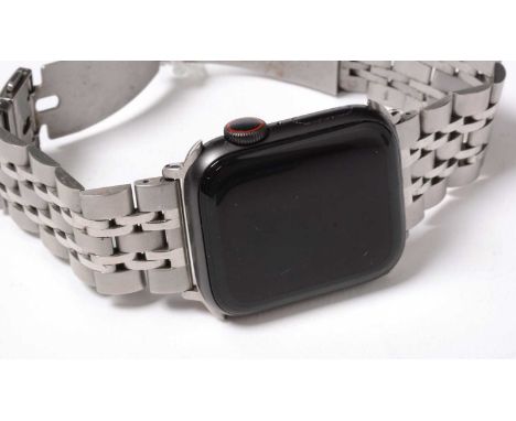 An Apple Watch, Series 5, with aluminum and ceramic case, on a bracelet strap.