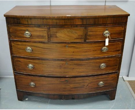 A Regency bowfronted chest of drawers, the shaped top above an arrangement of three short drawers over three long drawers, ra