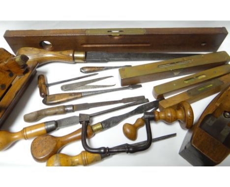 A good collection of antique carpentry tools including brass mounted spirit levels, planes, chisels etc