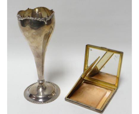 A square machine turned silver compact, Birmingham 1973; together with a hallmarked silver rose vase, 2.7gms