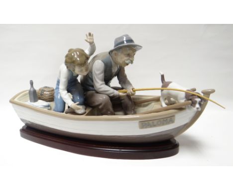 A large Lladro model of an old man, dog and boy apparently catching a fish within a rowing boat, named 'The Paloma', with woo