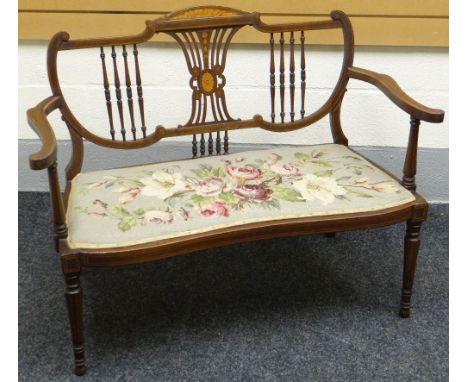 An inlaid mahogany Sheraton-style settee, with floral tapestry seat, circa 1910, 43ins wide (109cms) together with a carved g