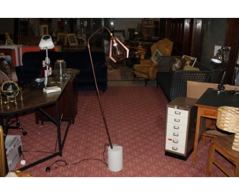 A modern scratched metal floor lamp with heavy base 