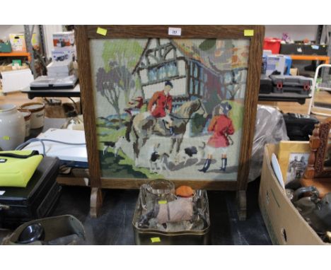 A 20th century oak fire screen with embroidered hunting scene decoration and sold together with hunting related glassware and