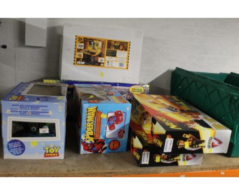 A small quantity of boxed toys to include Toy Story remote controlled car, a Spiderman remote controlled car, a JCB work benc