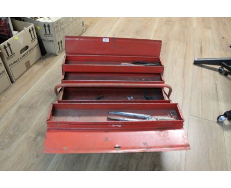 A red metal tool box with small number of tools 