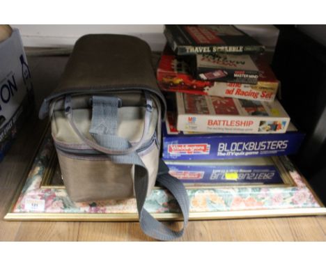 A floral framed rectangular mirror, small quantity of board games, and a cased containing Sanyo video camera