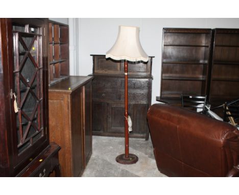 A reproduction standard lamp with fluted column and cream tasselled shade 