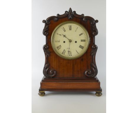 A 19th Century mahogany cased Bracket Clock having white enamel circular dial, two train fusee movement, the case with scroll