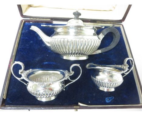 A Victorian silver three piece Tea Service of semi-fluted circular form with scroll rims, London 1895, in case