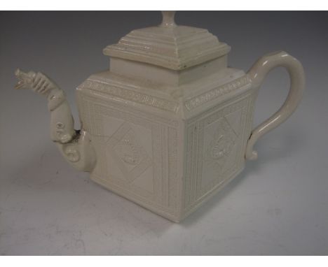 An 18th Century saltglaze diamond shaped Teapot moulded greek key borders, shell designs, spout with dragon end, A/F, and lid