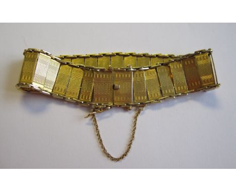A 9ct gold Bracelet with engine turned rectangular links and box clasp, approx 20gms