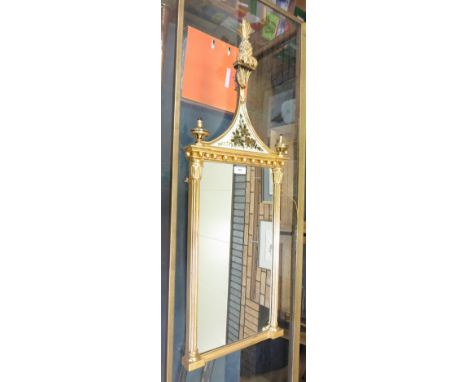 A gilt framed Pier Glass with arched top having pineapple finial, gilt decorated panel, reeded columns with leafage capitals 