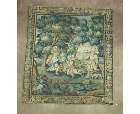 A 17th Century Flemish Verdure Tapestry with figures in parkland with a mansion in the background set in a wooded landscape, 