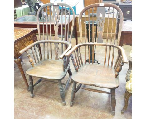 A near pair of 19th Century Windsor Elbow Chairs with pierced splat and stick backs, solid seats on turned legs with H Stretc