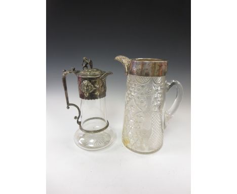 A Victorian silver mounted large cut-glass Claret Jug, London 1900, A/F, and a plated mounted Claret Jug with mask frieze and