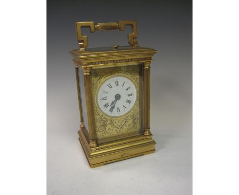 A brass cased Carriage Clock by Charles Frodsham, eight day striking movement, circular white enamel face with engraved brass