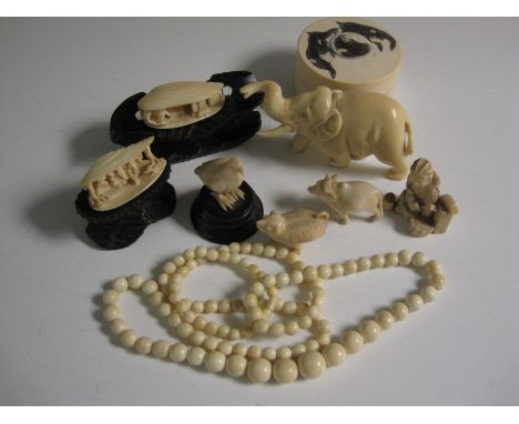 A small collection of ivory and bone Carvings including an elephant, two shells, bird, animals, seated figure, box and cover,