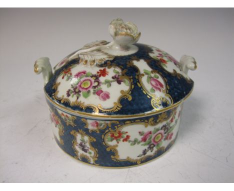 A Worcester lidded Butter Dish, the lid with floral finial, panels of flowers on scale blue ground, A/F, the base with two ha