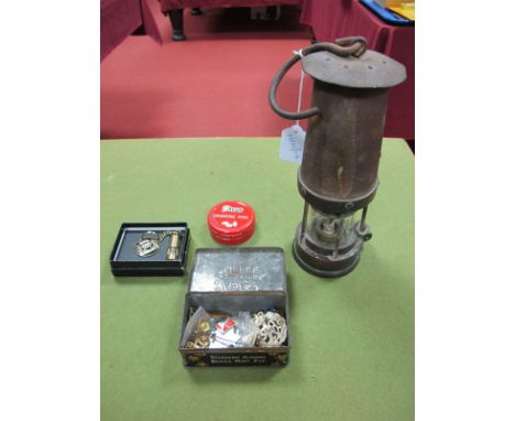 A Miners Lamp, stamped "Davis 2 Kirkby"; together with a miners lamp keyring, enamel and other badges, pins, etc. 