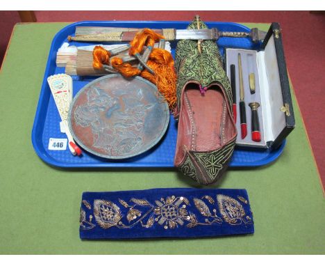 An African Dagger, skin and leather sheath and grip, Oriental embroidered slippers, cap, fans, cased seal set, etc:- One Tray