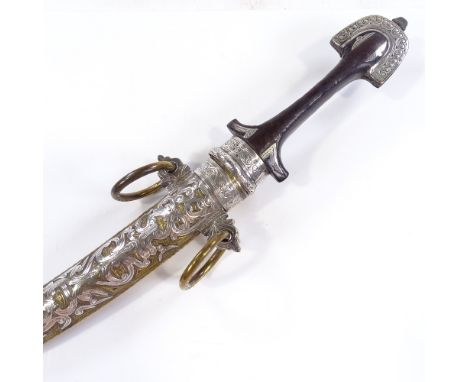 An Arab dagger with ornate brass and white metal-mounted scabbard, overall length 40cm 