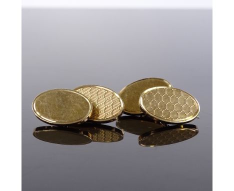 A heavy pair of oval 9ct gold cufflinks, with engine turned and plain decorated panels, panel length 18.8mm, 14.6g total 