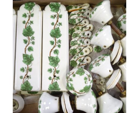 A collection of French porcelain door furniture, including 6 pairs of door finger plates, 12 keyhole covers, several pairs of