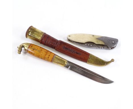 A traditional Finnish Puukko belt knife in leather scabbard, signed blade and brass horse design pommel, length 22cm, togethe