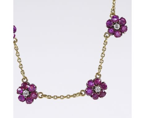 An 18ct gold ruby and diamond cluster flowerhead collar necklace, flowerhead diameter 8.5mm, necklace length 43cm, 8.2g 