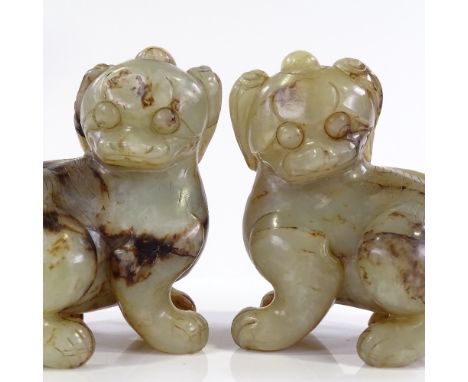 A pair of Chinese carved green stone/jade Dogs of Fo, height 14cm, length 13cm 